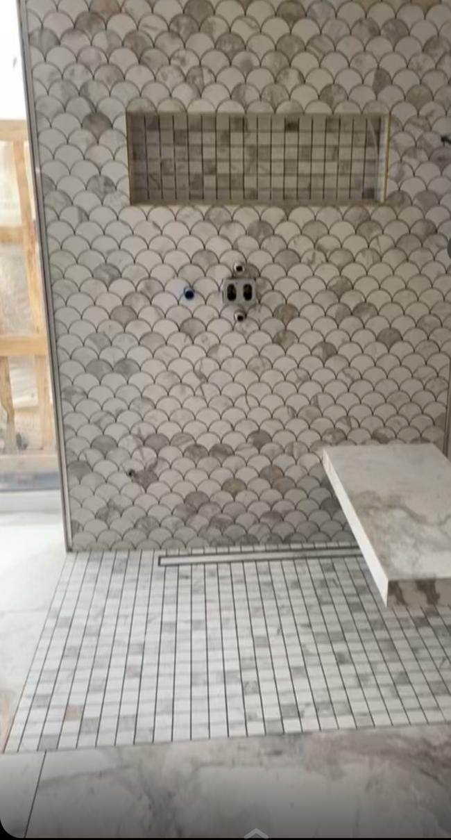 Douche de plain-pied en mosaïque écailles effet marbre blanc et gris, sol en petite mosaïque, caniveau linéaire, niche en mosaïque et banquette suspendue, réalisation à Évian-les-Bains